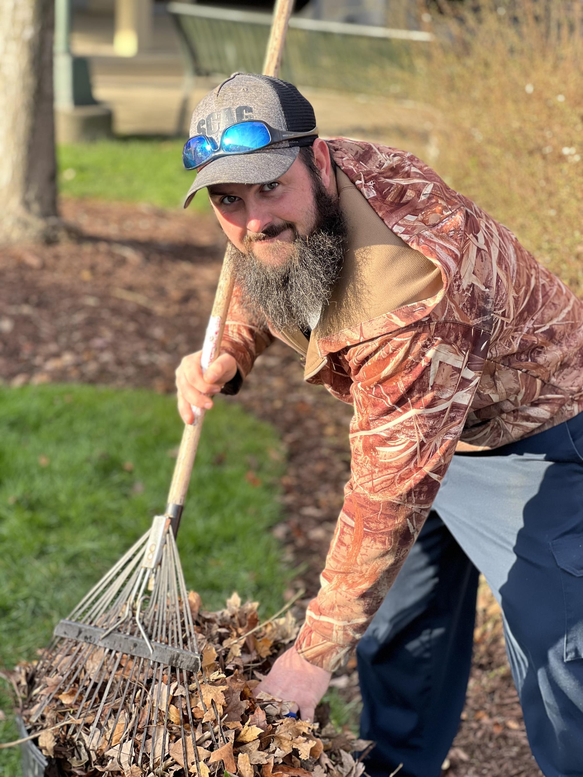 Kevin Luther rakes leaves at Market Station