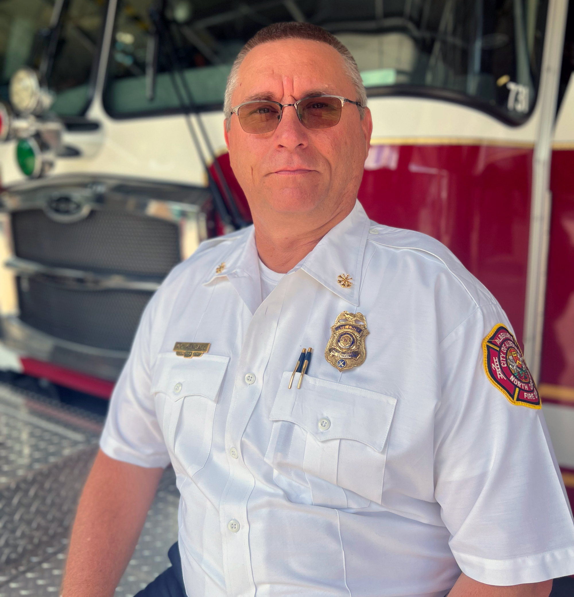 Assistant Fire Chief Kenny Kendall sitting on a fire truck